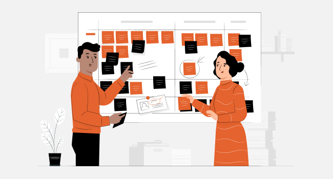 male and female managers standing in front of the board with stickers and replacing them